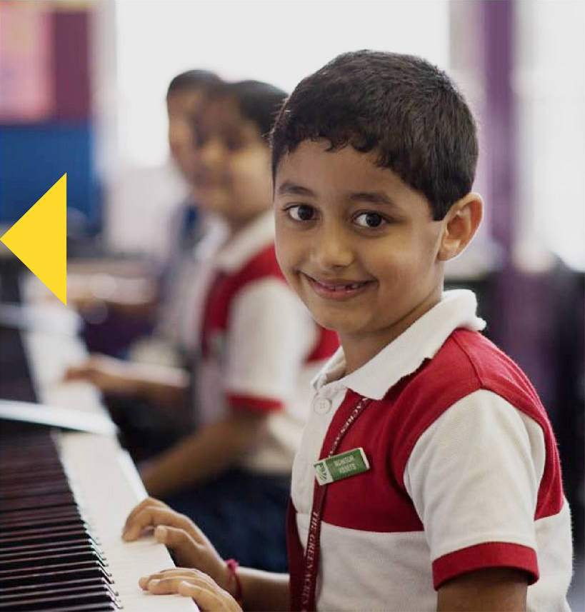Students of The Green Acres Academy (TGAA) school in Mumbai playing piano.