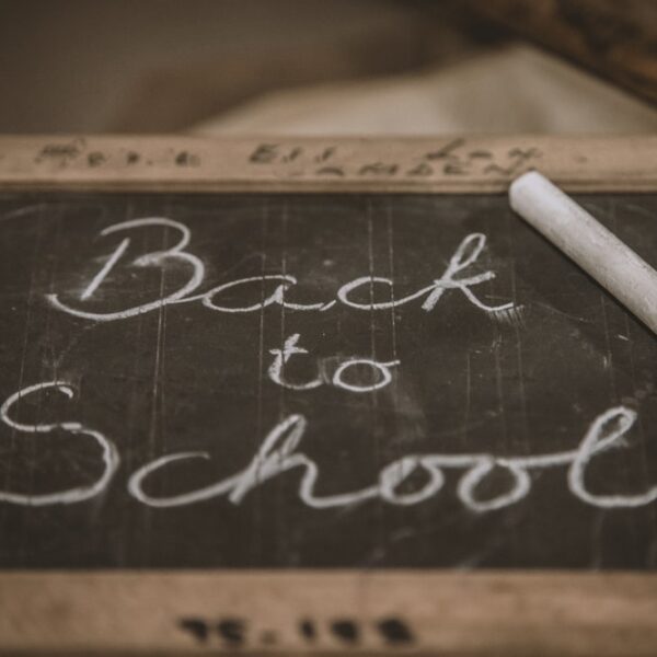 “Back to School” written on a slate with chalk.