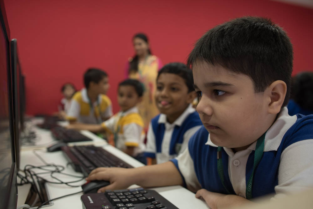 TGAA (The Green Acers Academy) students using computers in the computer lab.
